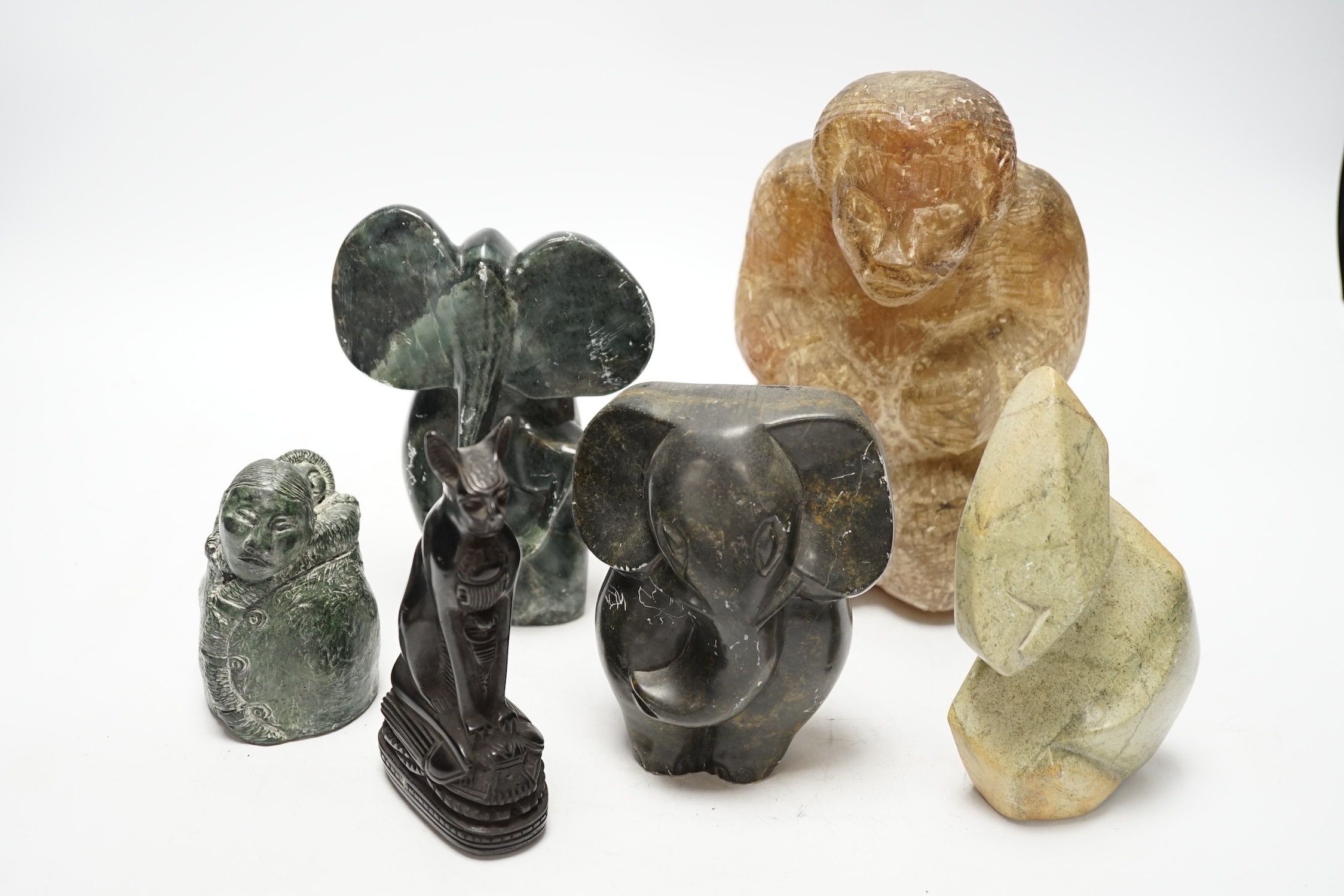 Six soapstone and marble carvings of Inuit figures, elephants, an Egyptian style cat, etc. tallest 22.5cm